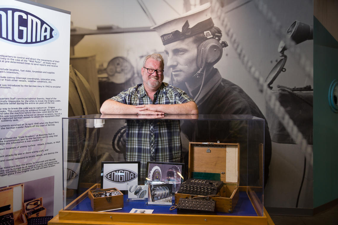 History prof John Ferris has been named the “Authorized Historian” in chronicling the history of the British communications intelligence agency (Government Communications Headquarters). Ferris stands next to an Enigma machine, a type of enciphering machine used by the German armed forces to send messages securely.