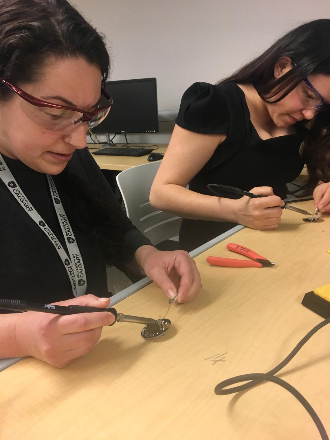 Participants at the She Leads: Soldering Workshop each made a small LED button.