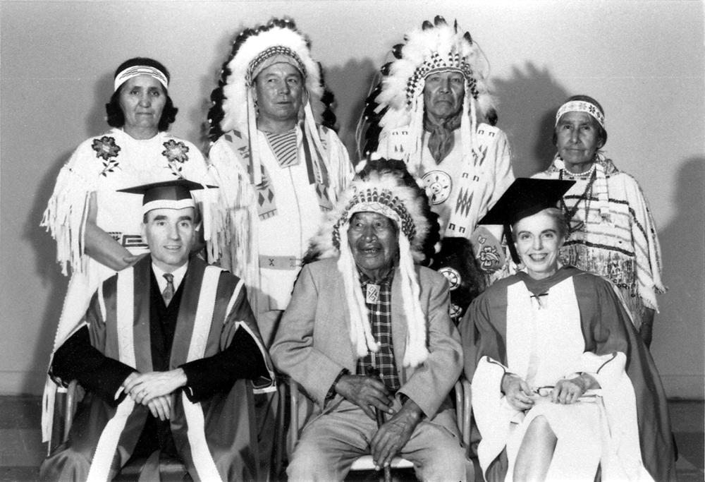 Daisy and David Crowchild, Howard and Mabel Beebe, President Herb Armstrong, Tatanga Mani (Walking Buffalo) and Ruth Gorman at the University of Calgary’s first convocation in 1966. Photo by Neil Crichton. 