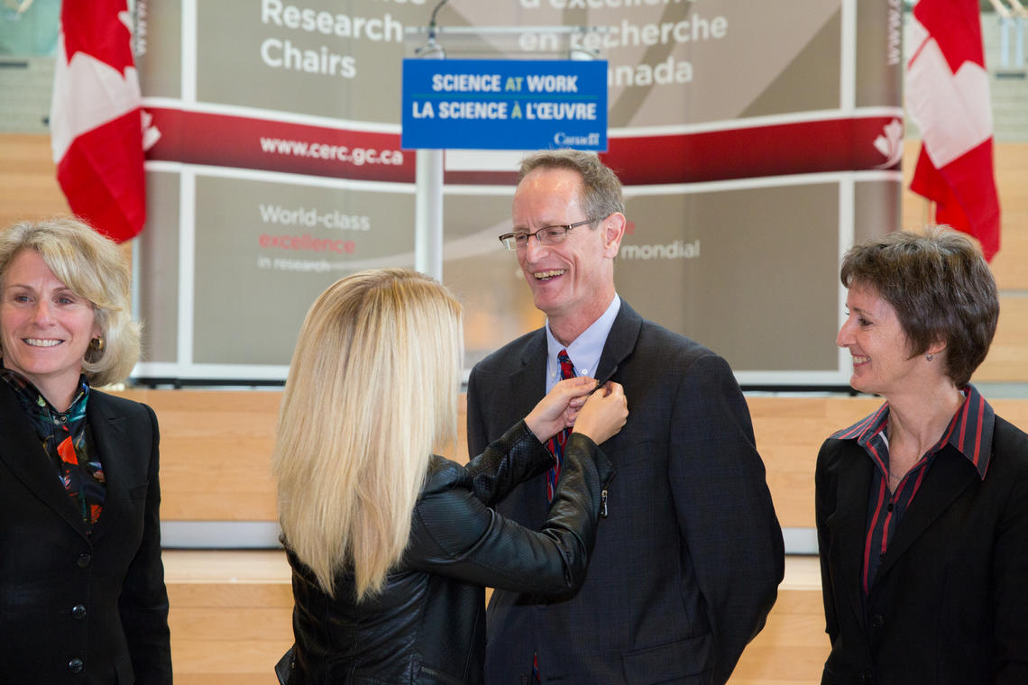 Steven Bryant is congratulated during a ceremony at the University of Calgary on Thursday. Among those taking part were, from left: university President Elizabeth Cannon, Minister of State (Western Economic Diversification) Michelle Rempel, and Janet Walden, chief operating officer of the Natural Sciences and Engineering Research Council of Canada.