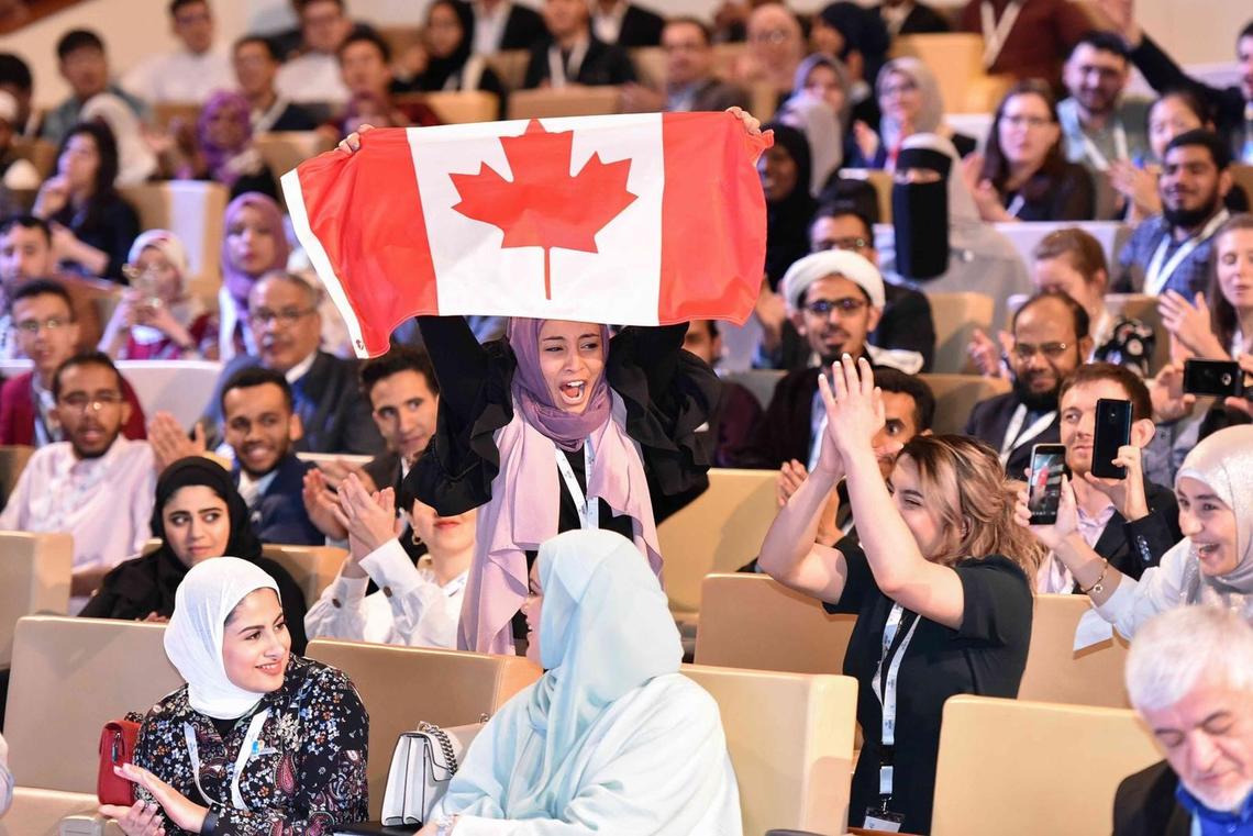 Canadian team member Heyam Abdulrahman celebrates the win, while teammate Rineem Saleh applauds.