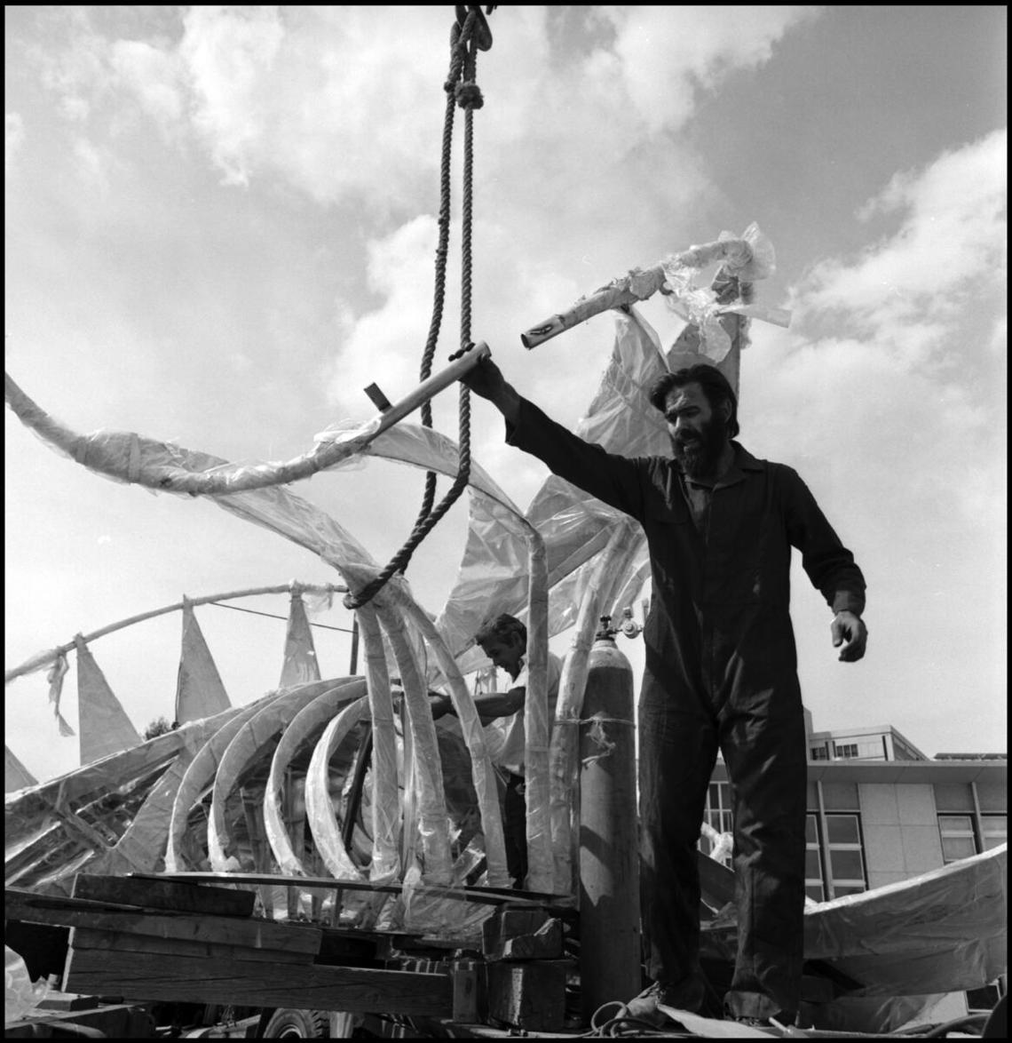  Image of George A. Norris with his untitled sculpture (dubbed The Prairie Chicken by students) on a flatbed trailer preparing the top of the sculpture for installation