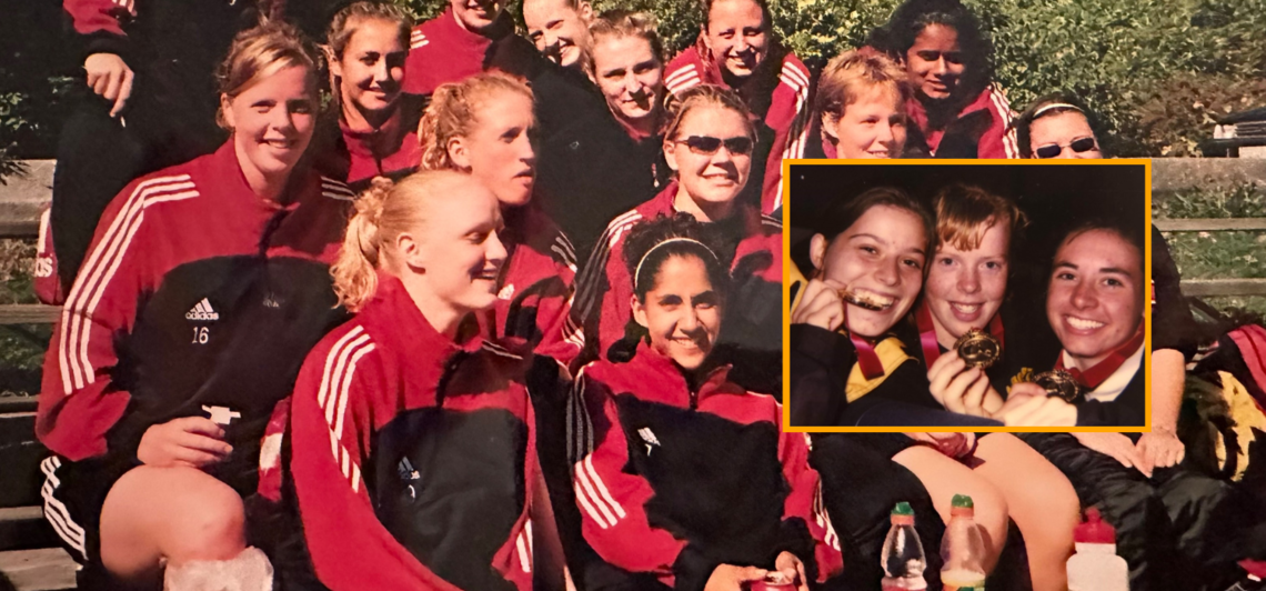 UCalgary staff Sue Miller with her gold medal, surrounded by a soccer team in red and black jackets