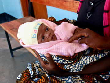 A two-day-old baby awaits a checkup at a health facility in Misunwi District, Tanzania.