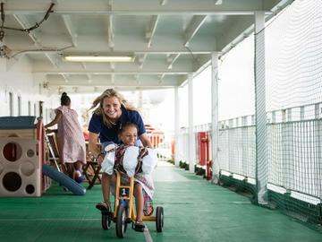 Tara McHardy plays with a patient on board