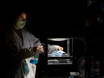 Dr. Heyne is in spotlight as she uses the light rig in her laboratory to activate the methylene blue solution