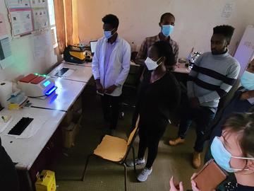 Group of people using lab machines in a clinic in Ethiopia.