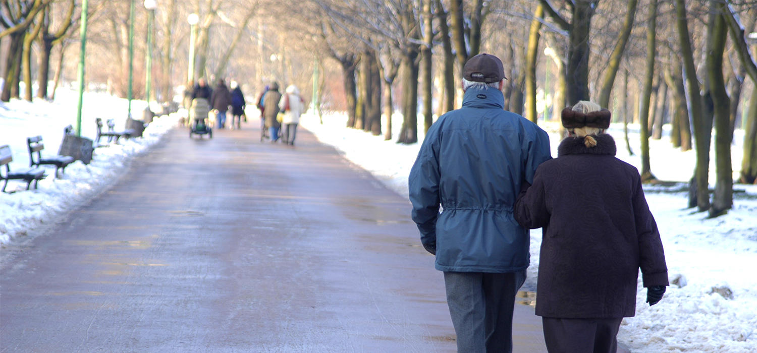 Seniors walking in springtime snow