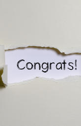 The word congrats appearing behind torn paper