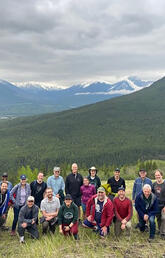  Electricity camp 2022 participants standing on hill in front of mountain