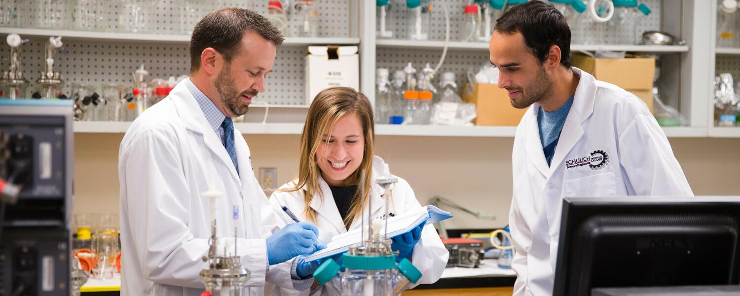 UCalgary students in a lab with white lab coats
