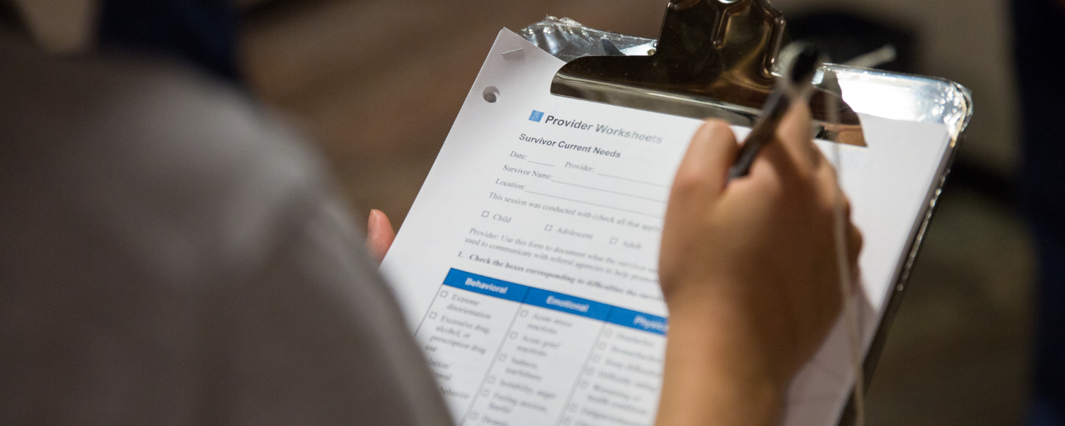 Doctor of Nursing student writing on clipboard