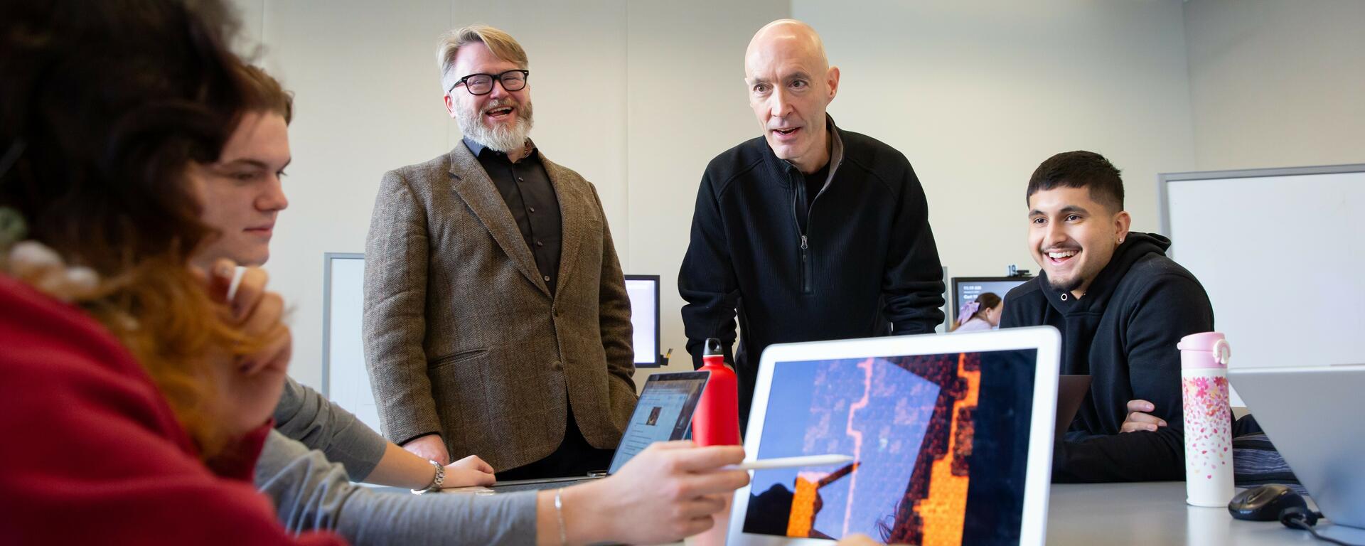 Photo of a male supervisor with a student next to him