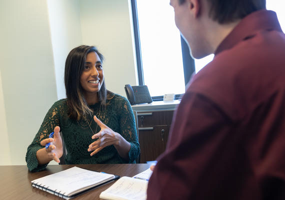Jaya helping a student