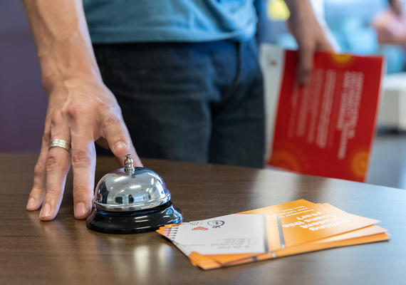 Photo of a person ringing a bell for assistance