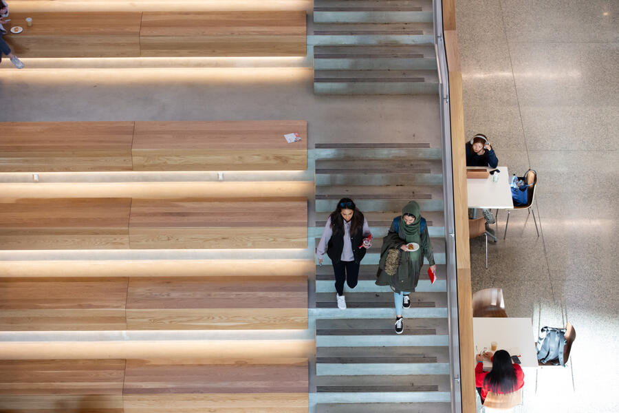 Student walking down the study stair in the new Mathison Hall building