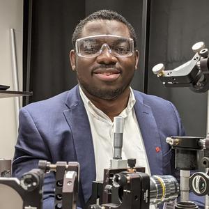 Dr. Tiamiyu in the laser induce particle impact tester (LIPIT) lab at MIT.