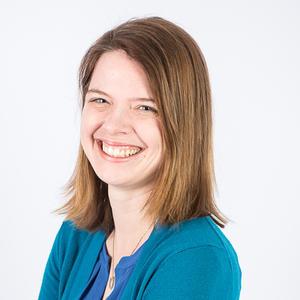 white woman with brown hair and teal cardigan