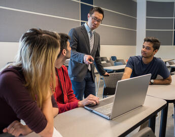 Faculty with students in a classroom