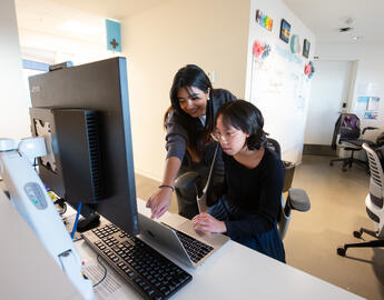 Student with faculty member at the Cumming School of Medicine's Student Run Clinic